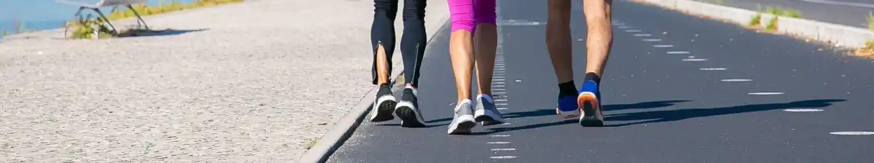 Group of three people walking down the street