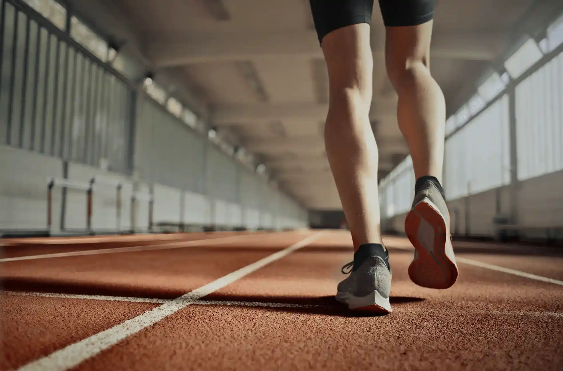 close up of tennis shoes walking on indoor track