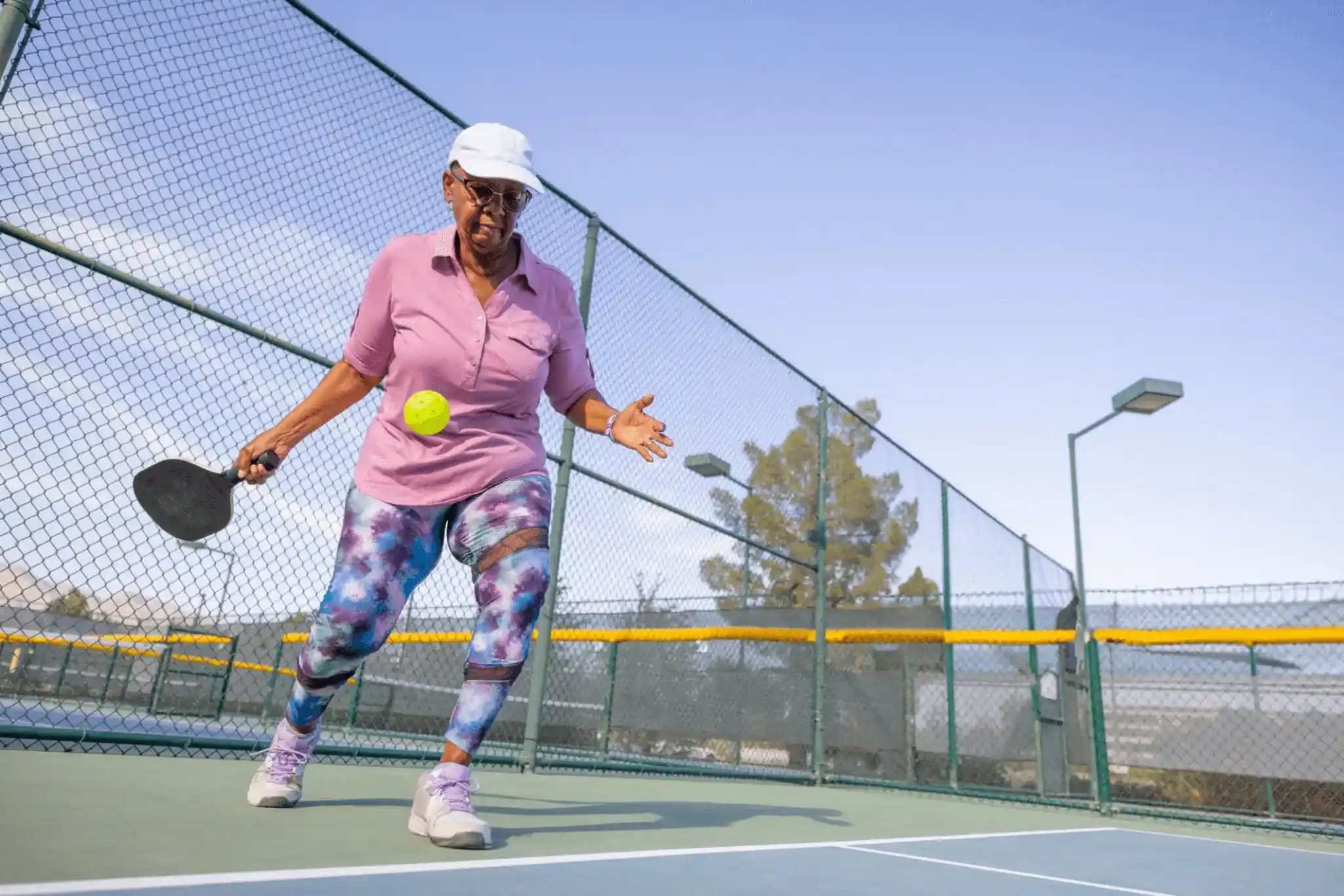 older person playing pickle ball in mount dora